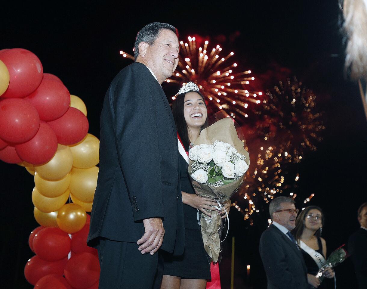 Lea Patao, with her father Derek, after being named homecoming queen, with a good fireworks show over their heads for homecoming at La Canada High School on Friday, October 19, 2018. The homecoming queen is Lea Patao.