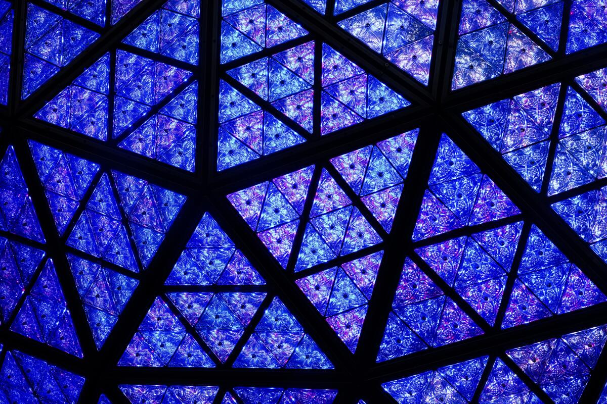 A close-up look at New Year's Eve ball reveals a geometric pattern in blue and purple.