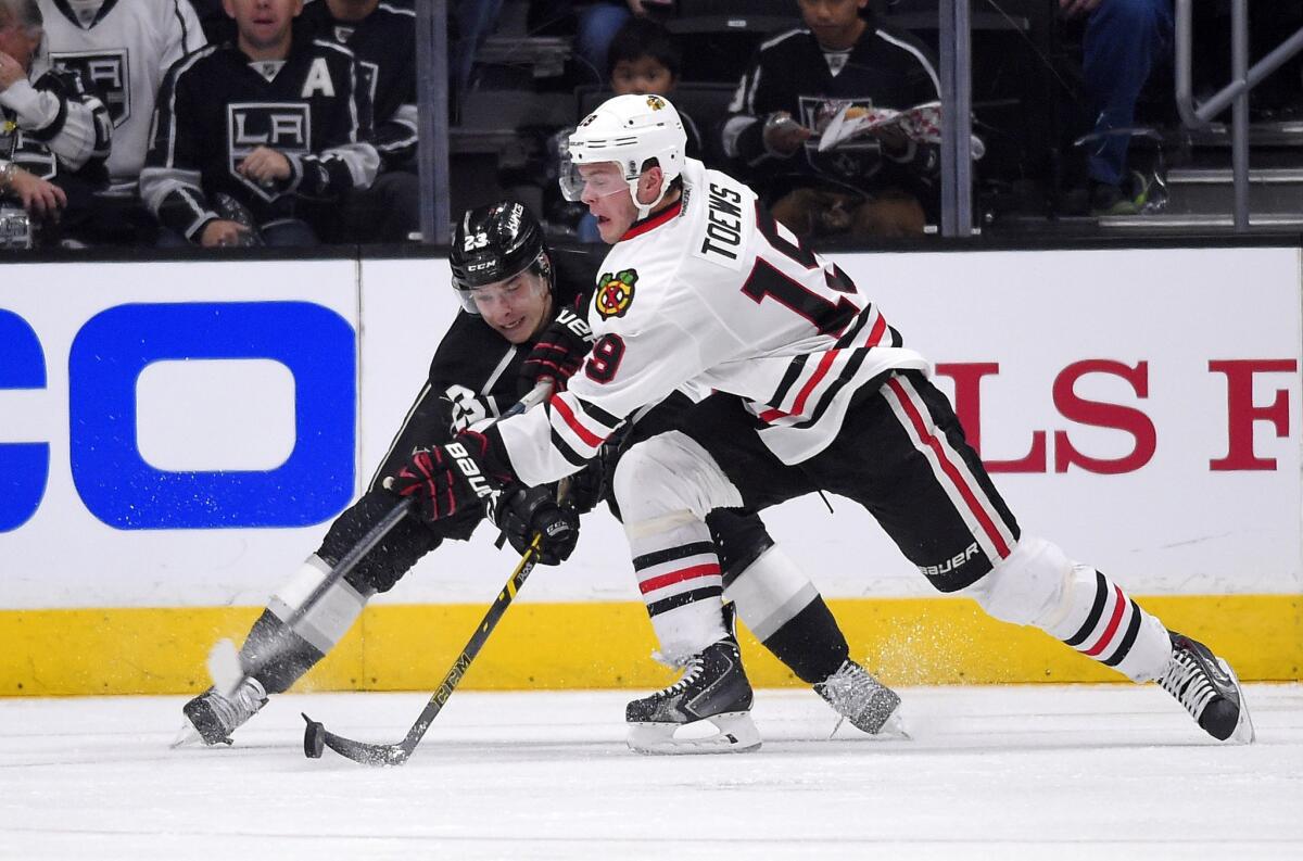 Dustin Brown and Blackhawks center Jonathan Toews mix it up during the second period of the Kings' 4-3 win Wednesday over Chicago at Staples Center.