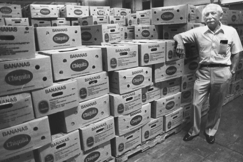 Images from the Los Angeles Times 1984 Pulitzer Prize Award for Public Service, "Latinos", a 27-part series on Southern California's latino community and culture in the early 1980s. July 15, 1983 Robert Alvarez stands beside boxes of bananas in one of his warehouses. (Los Angeles Times / Aurelio Jose Barrera)