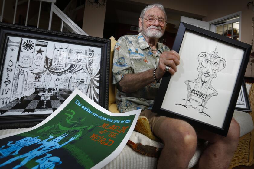 Rolly Crump, the last surviving Disney "Imagineer" who worked on the Haunted Mansion ride and many others at Disneyland is surrounded August 2, 2019, in Carlsbad, California by artwork he created for the Museum of Weird that was to be part of the Haunted Mansion, but never became a reality because Walt Disney died before it could be done. The ride celebrates its 50th anniversary on August 9. His Haunted Mansion artwork was sold at auction, or is in storage and not available.