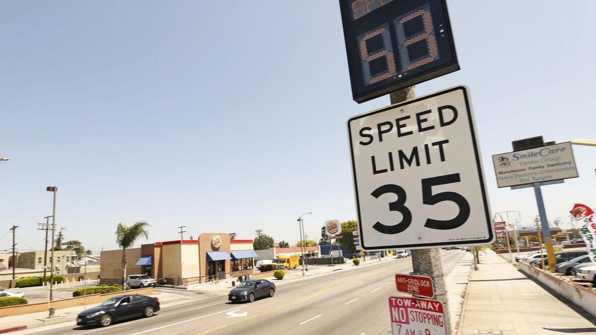 A new digital sign records a vehicle's speed as 53 mph in a 35-mph zone on Manchester Avenue, one of the deadliest streets in Los Angeles for pedestrians and bicyclists.