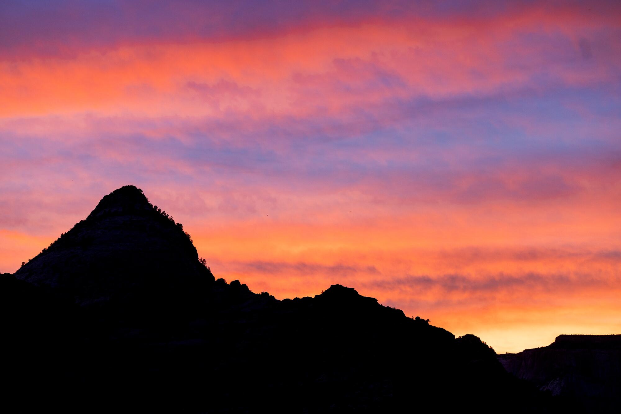 The setting suns casts a colorful palette in the skies above Zion Canyon at the end of the Canyon Overlook trail 