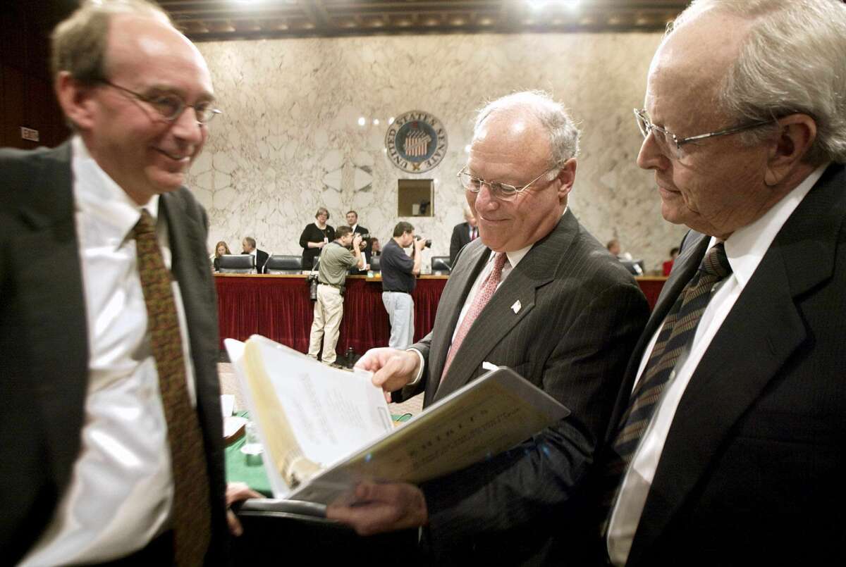 Neil Eggleston, left, then a lawyer for Enron's board of directors, speaks with Dr. Herbert Winokur, Jr., center, and John Duncan, both former members of the board.