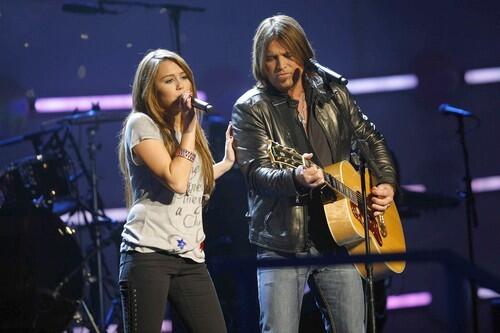 Miley Cyrus and her father, Billy Ray, performing at the Kids' Inaugural: We Are the Future concert in Washington, D.C.