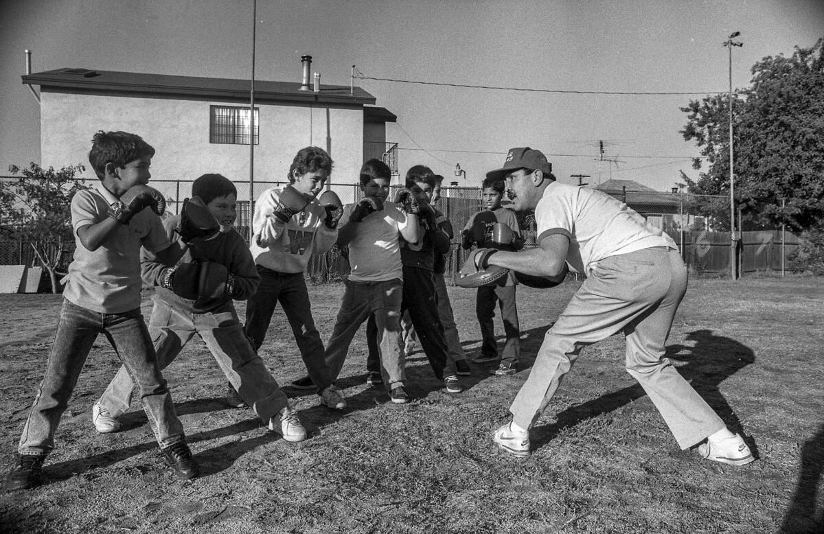 Dec. 22, 1988: Mando Ramos, former world lightweight champion, works with young boxing prospects at Mahar House on the east side of Wilmington.