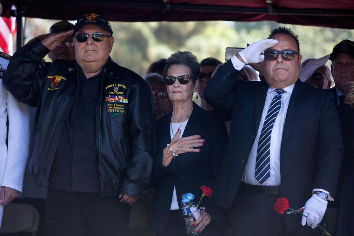 Ruben Valencia, Emily Valencia and Ruben Valencia Jr. give a salute as the funeral begins for Raul Guerra at Rose Hill Memorial Park on April 24, 2019, in Whittier, California. (Dania Maxwell / Los Angeles Times)