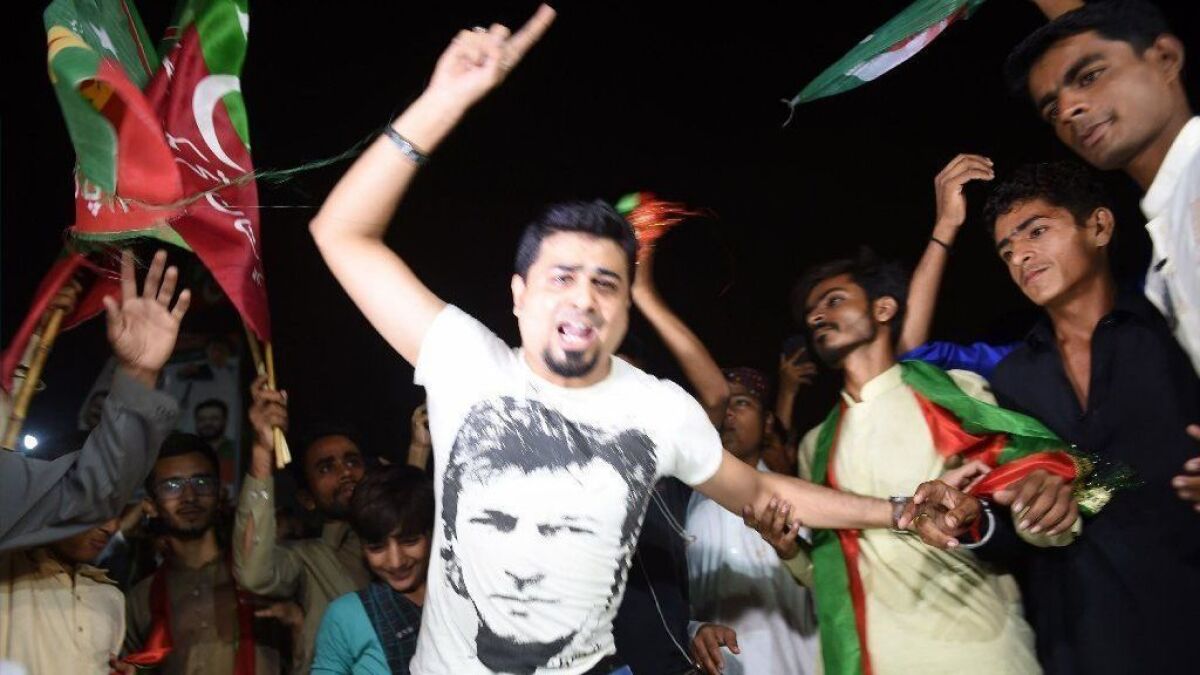 Supporters of Pakistan's cricketer-turned politician Imran Khan celebrate in Karachi on July 26, 2018, as Khan claimed victory in a general election.