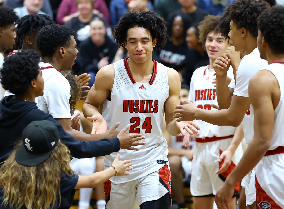 Centennial High guard Jared McCain greets teammates during introductions before a game.