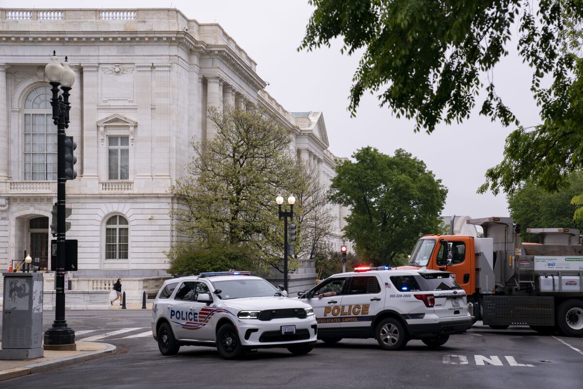Police vehicles and heavy trucks block access to Supreme Court Building in Washington, Wednesday, May 4, 2022, as security measure are enhanced on the perimeter following protests sparked by news that the court might overturn cases that guarantee abortions. More demonstrations are expected in the wake of a Politico story about Supreme Court Justice Samuel Alito's draft majority opinion, which sets the stage for the court to overturn Roe v. Wade and Planned Parenthood v. Casey. (AP Photo/J. Scott Applewhite)