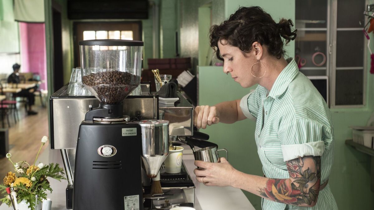 Cuties Coffee, which bills itself as the only LGBTQ-focused coffee shop in Los Angeles, is fighting to stay open at a time when the city has already lost other queer-owned establishments. Here, co-owner Virginia Bauman prepares a latte.