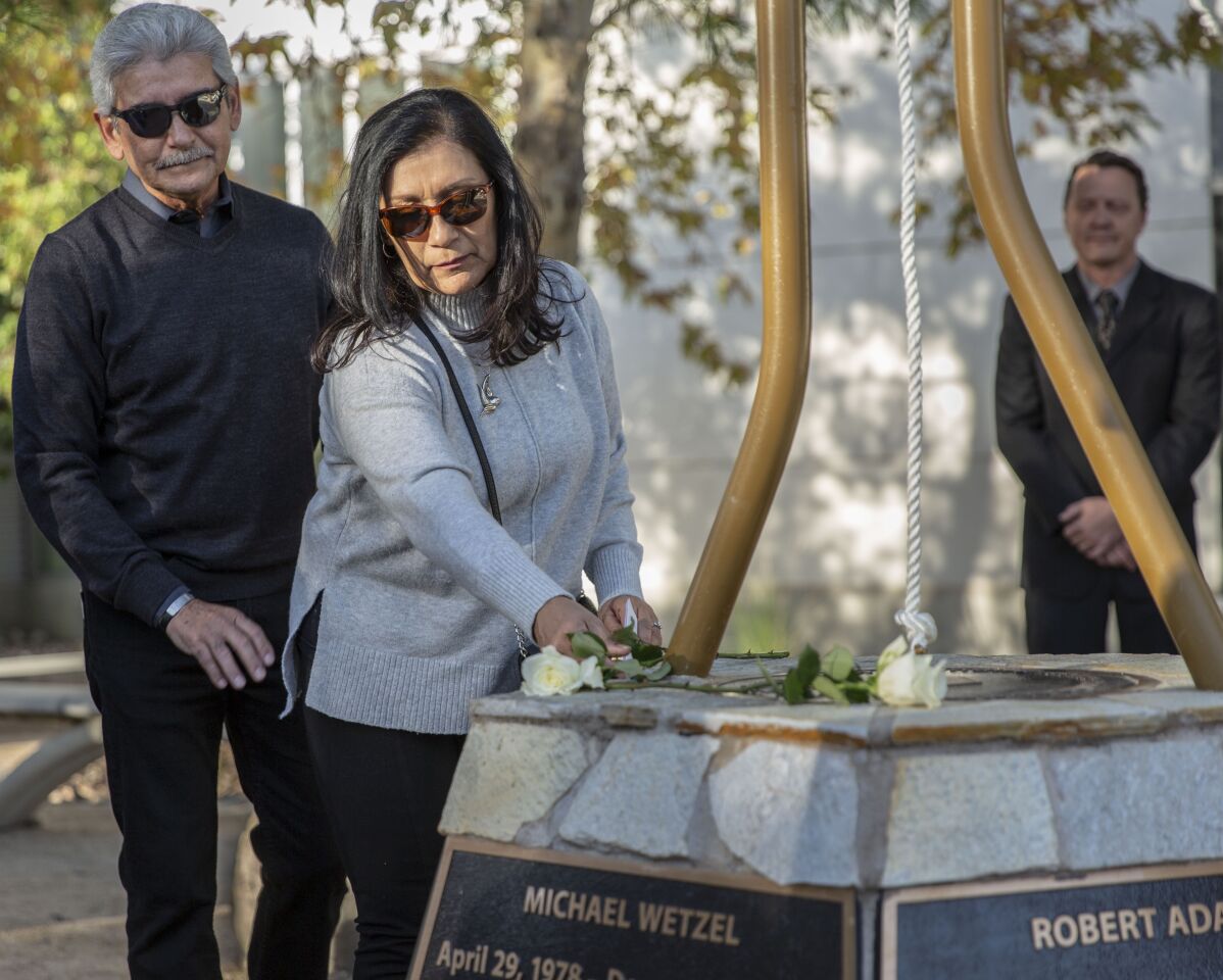 Marie Velasco places a rose for her daughter, Yvette Velasco, at a memorial at Cal State San Bernardino on Monday. Yvette Velasco was one of the youngest victims at the mass shooting in San Bernardino four years ago that left 14 people dead and 22 others wounded.