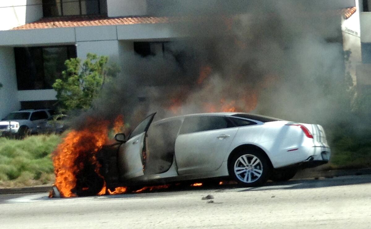Dick Van Dyke's car burns on the side of the 101 freeway between Calabasas and West Hills on Monday afternoon. Photo by Dan Santos / Los Angeles Times.