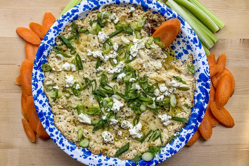 Lemon-Pepper Chicken Dip: Square baking dish with carrots, celery, and pita chips.