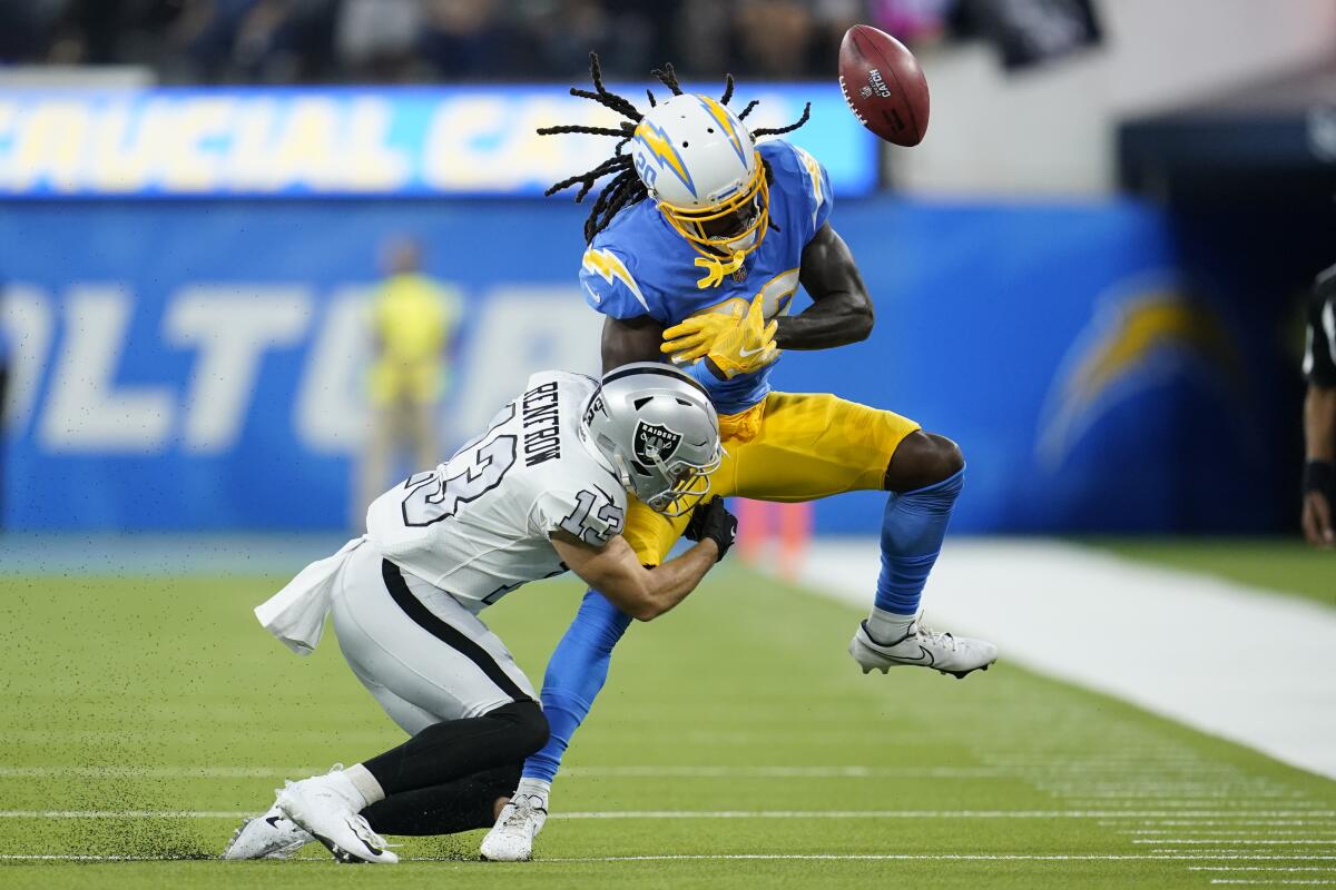 Chargers cornerback Tevaughn Campbell can't make the catch as he is hit by Raiders defender Hunter Renfrow.