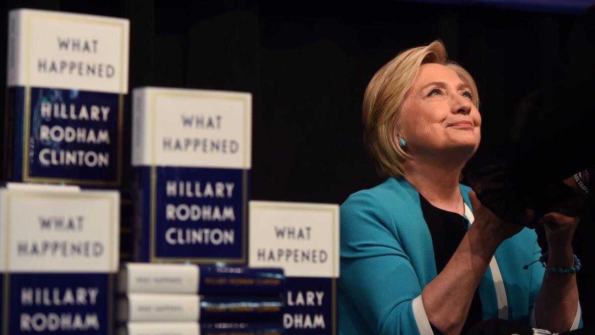 Hillary Clinton signs "What Happened" in New York on Tuesday.