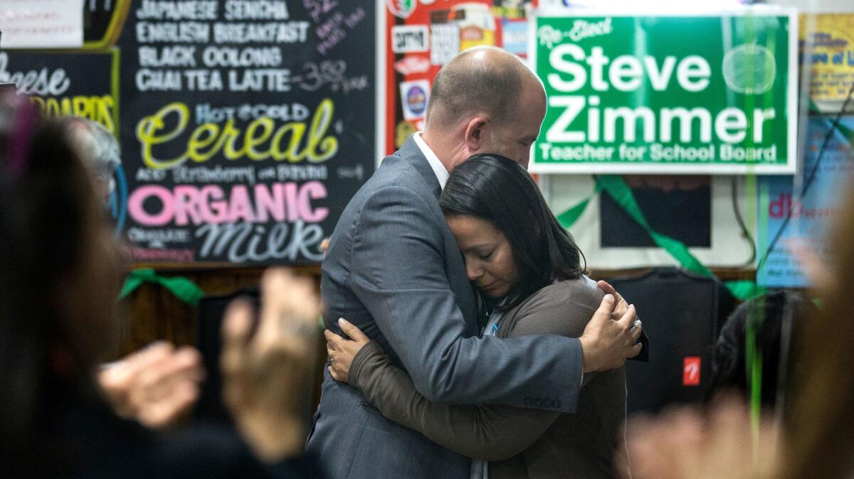 LAUSD board president and incumbent District 4 member Steve Zimmer, left, embraces Anika Fernandez, right, following an impassioned concession speech at his election night gathering in Venice.