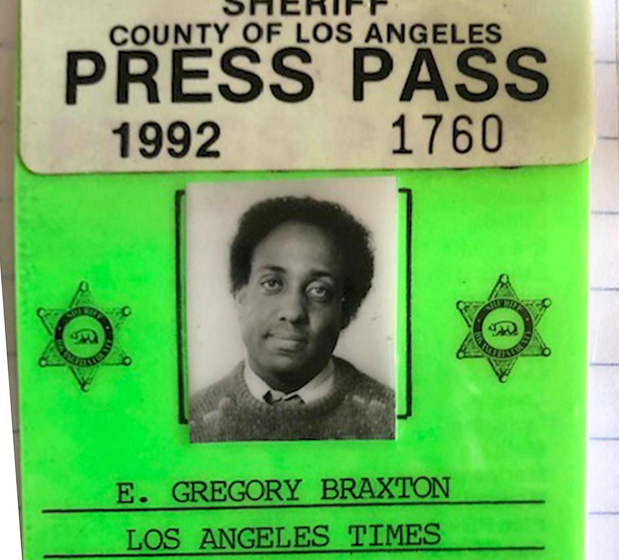 A bright green L.A. County press pass reads E. Gregory Braxton, Los Angeles Times