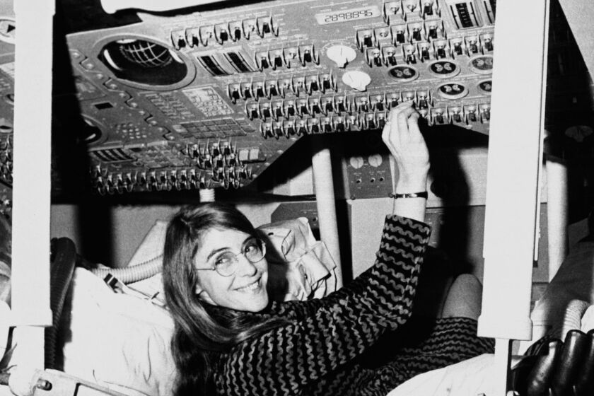 Margaret Hamilton, mathematic and computer programmer at the MIT Instrumentation Laboratory, sits in a mockup of the Apollo command module.