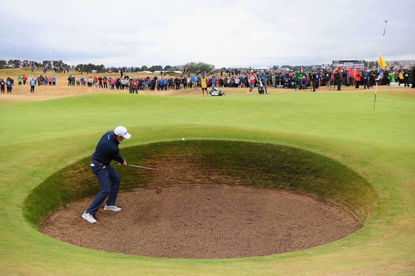 Justin Rose of England plays a shot from a bunker on the third hole during the second round of the British Open.