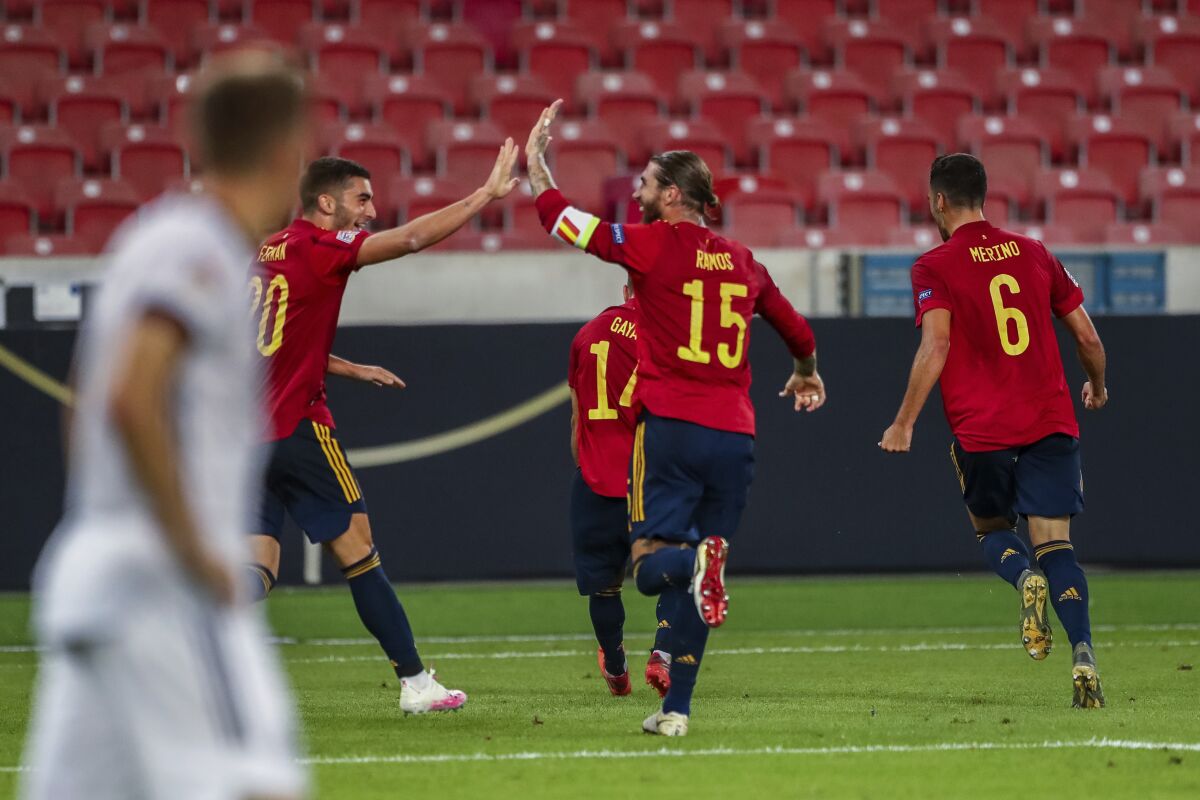 Spain players celebrate after scoring during the UEFA Nations League soccer match against Germany at the Mercedes-Benz Arena stadium in Stuttgart, Germany, Thursday, Sept. 3, 2020. (AP Photo/Matthias Schrader)