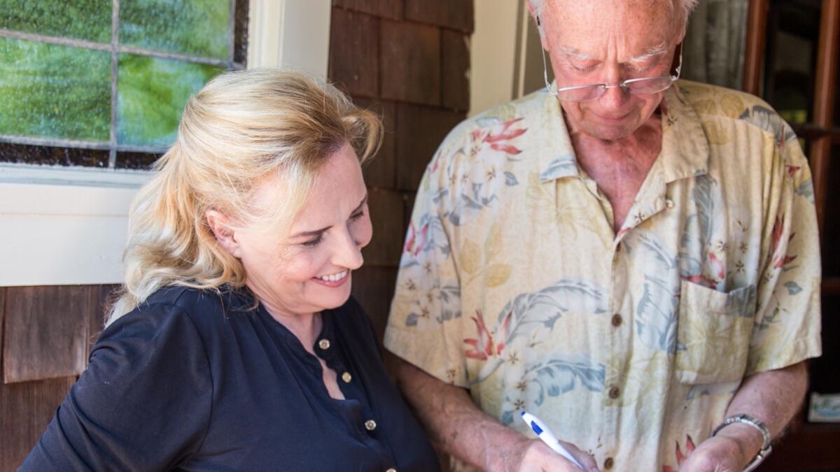 Allison Mathews gets a signature from Laguna Beach resident John Cloak to support her candidacy for the City Council.