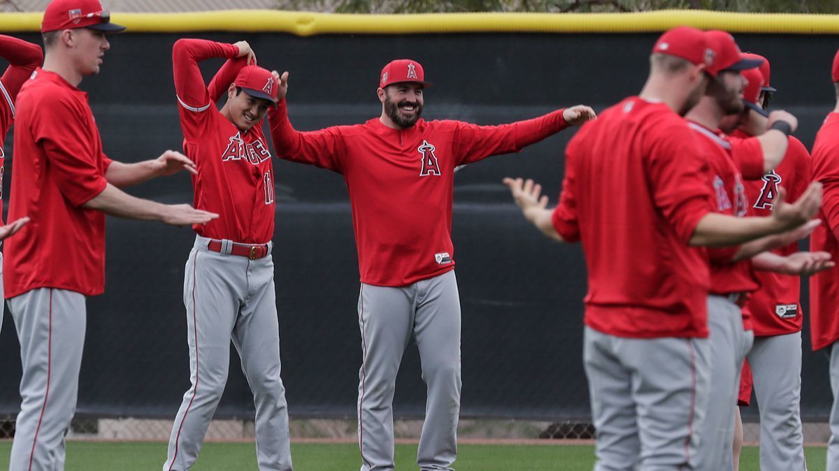 Angels pitcher Blake Parker stretches with teammates during a spring training session at Tempe Diablo Stadium in Tempe, Ariz.