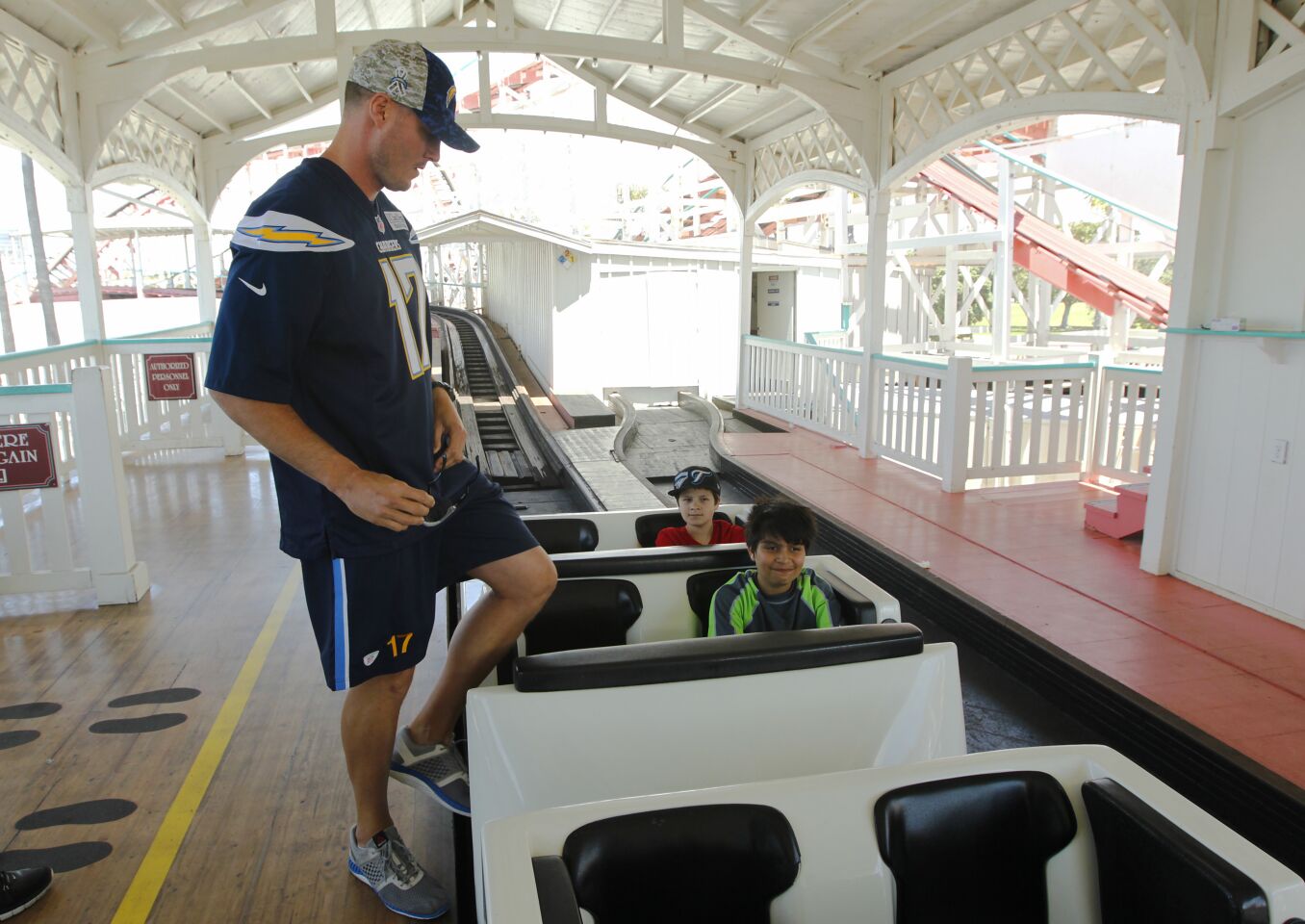 San Diego Chargers quarterback Philip Rivers prepares to ride the Giant Dipper roller coaster with fans at Belmont Park in Mission Beach during the Chargers' Thank You San Diego Day on May 25, 2016.