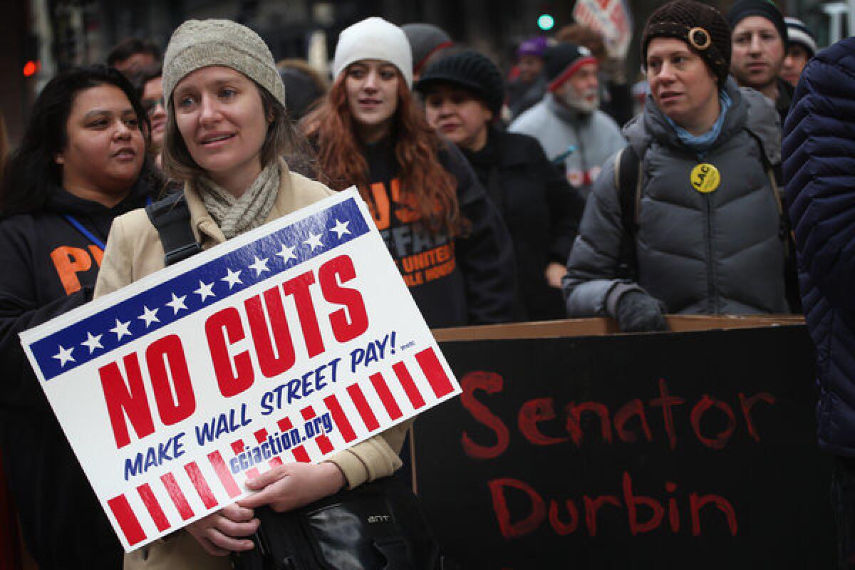 Protestors call for an increase of taxes on the wealthy and voice opposition to cuts in Social Security, Medicare, and Medicaid during a demonstration in Chicago.