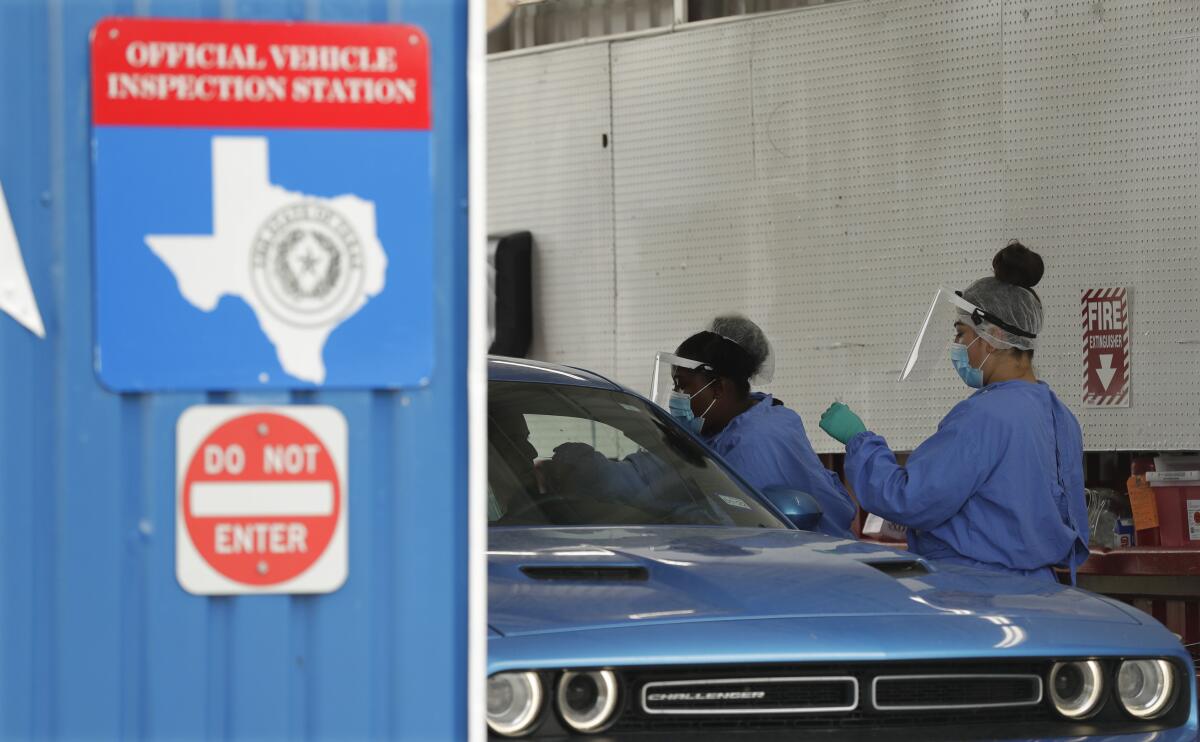 COVID-19 antibody and diagnostic testing are administered at a converted vehicle inspection station Tuesday in San Antonio. 