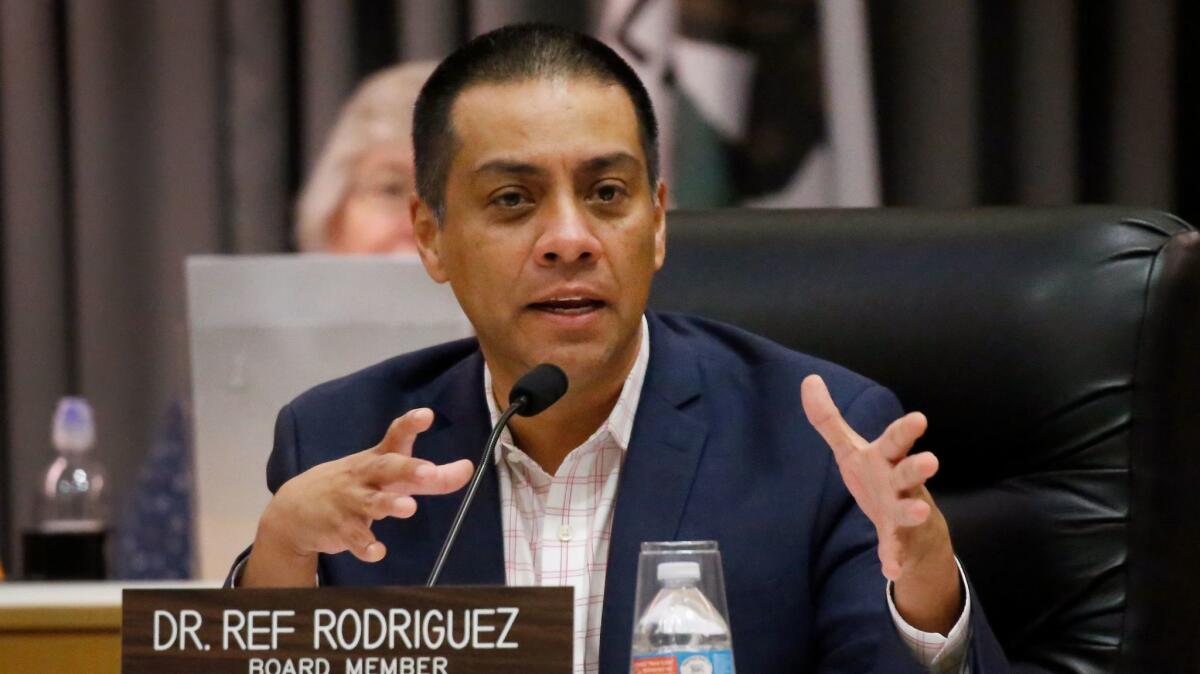 L.A. school board member Ref Rodriguez, who faces criminal charges, defied critics and cast votes Tuesday, but his choices were not critical on a series of unanimous decisions.