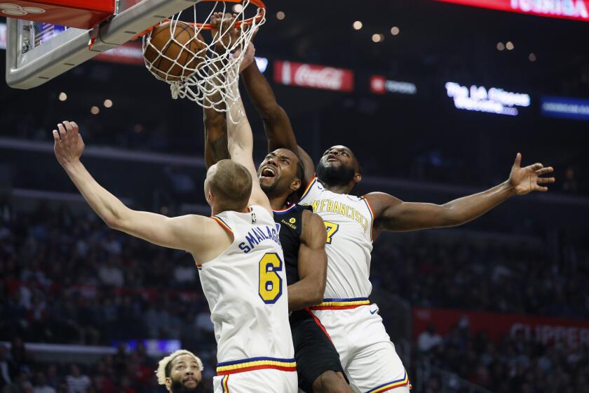 Clippers forward Kawhi Leonard dunks against Warriors forwards Alen Smailagic (6) and Eric Paschall during the first half of a game Jan. 10, 2020, at Staples Center.