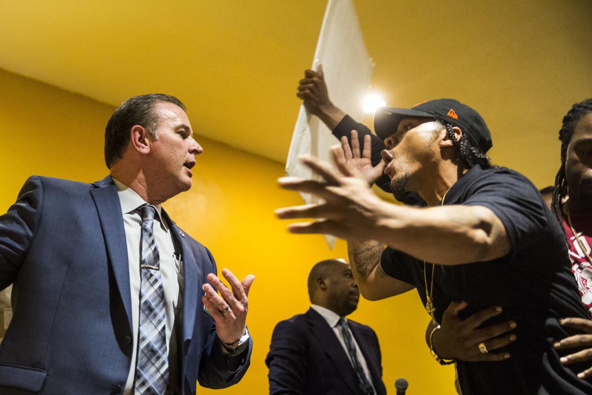 Sheriff's Capt. Christopher Bergner and John Weber, the older brother of Anthony Weber, exchange words during an emergency town hall meeting hosted by the Sheriff Civilian Oversight Commission in February.