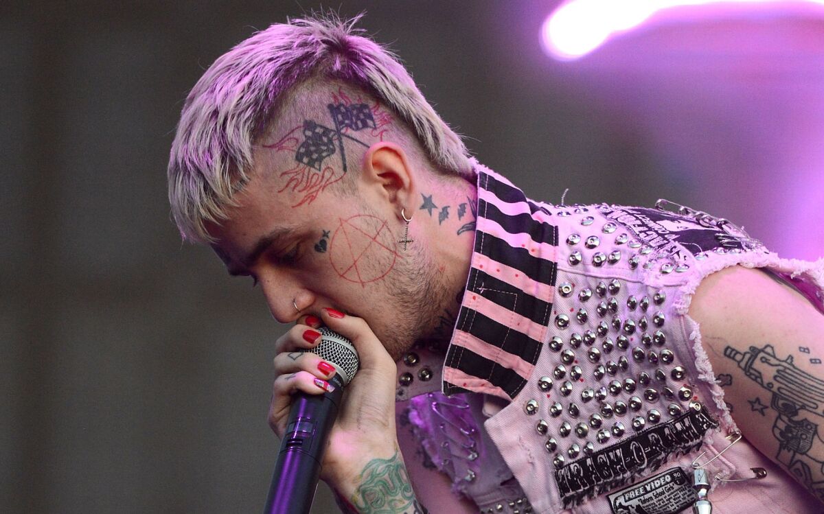 Lil Peep, microphone held right to his mouth, performs in Anaheim on Sept. 8, 2017.