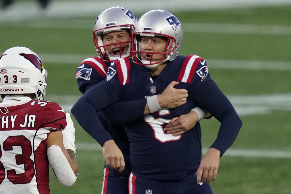 New England Patriots kicker Nick Folk, front, celebrates his winning field goal with holder Jake Bailey.