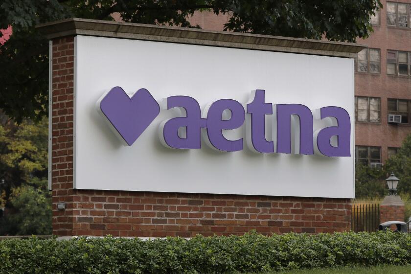 FILE - A sign sits on the campus of the insurance and managed health care company Aetna, Aug. 28, 2020, in Hartford, Conn. Aetna has agreed to settle a lawsuit that accused the health insurer of discriminating against LGBTQ+ patients. (AP Photo/Bill Sikes, File)