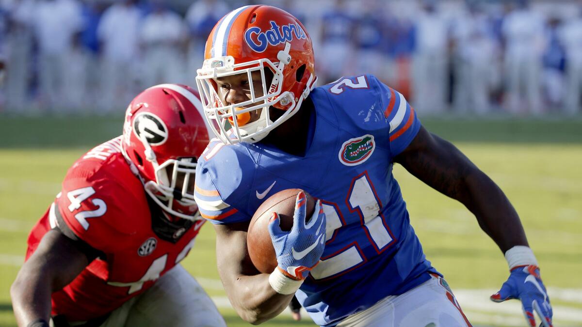 Florida running back Kelvin Taylor runs past Georgia linebacker Tim Kimbrough for a touchdown in the first half Saturday.