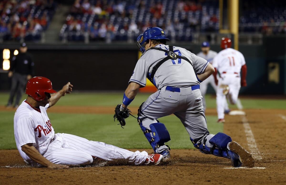 Dodgers catcher A.J. Ellis makes the catch to force out Phillies center fielder Ben Revere in the seventh inning Friday night.