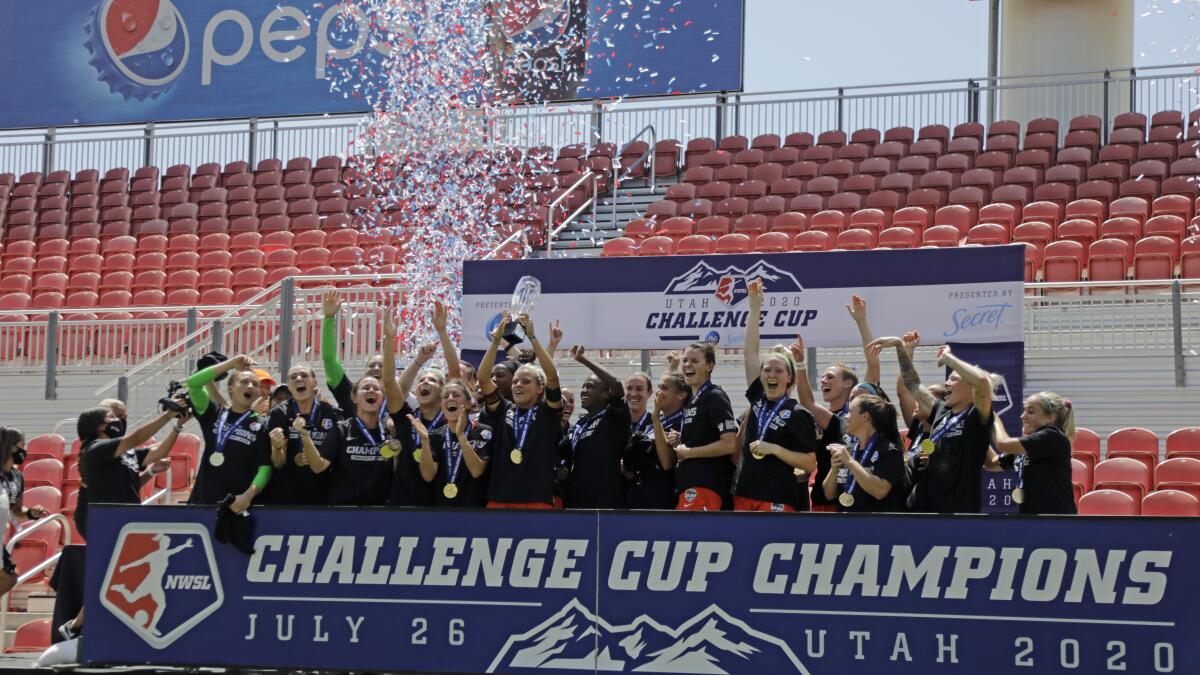 Houston Dash's Rachel Daly hoists the trophy with teammates after defeating the Chicago Red Stars.