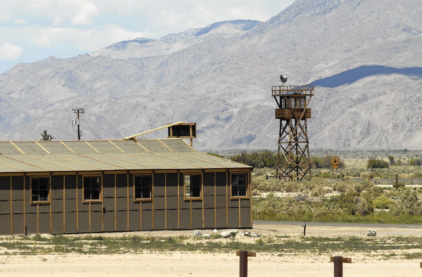 A replica internment barracks and guard tower.