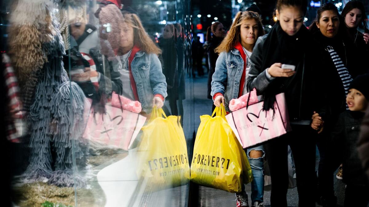 People carry shopping bags outside a mall in New York.