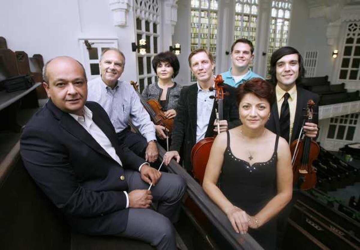 From left, some members of the Glendale Philharmonic include Meastro conductor Mikael Avetisyan, First Baptist Church of Glendale senior pastor Charles Updike, violinist Shushan Akopyan, GP founder and cellist Ruslan Biryukov, church Rev. Matt Andrews, soprano soloist Marina Abrahamyan-Abdasho and violinist and orchestra director Edgar Sandoval at the church in Glendale. The Glendale Philharmonic will perform a holiday concert on Sunday at the church.