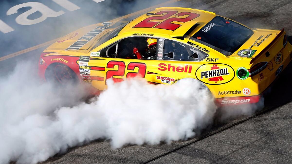 NASCAR driver Joey Logano celebrates after winning the Monster Energy NASCAR Cup Series Toyota Owners 400 at Richmond International Raceway on Sunday.