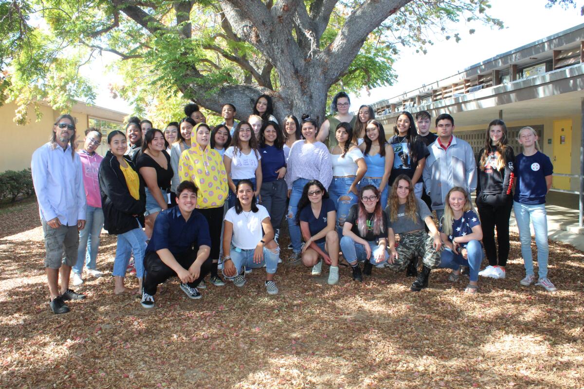 Members of the Mission Bay High School 2020 yearbook staff, with chief editor Kimberly Torres in front in dark glasses. Yearbook adviser Ron Lancia is on the left.