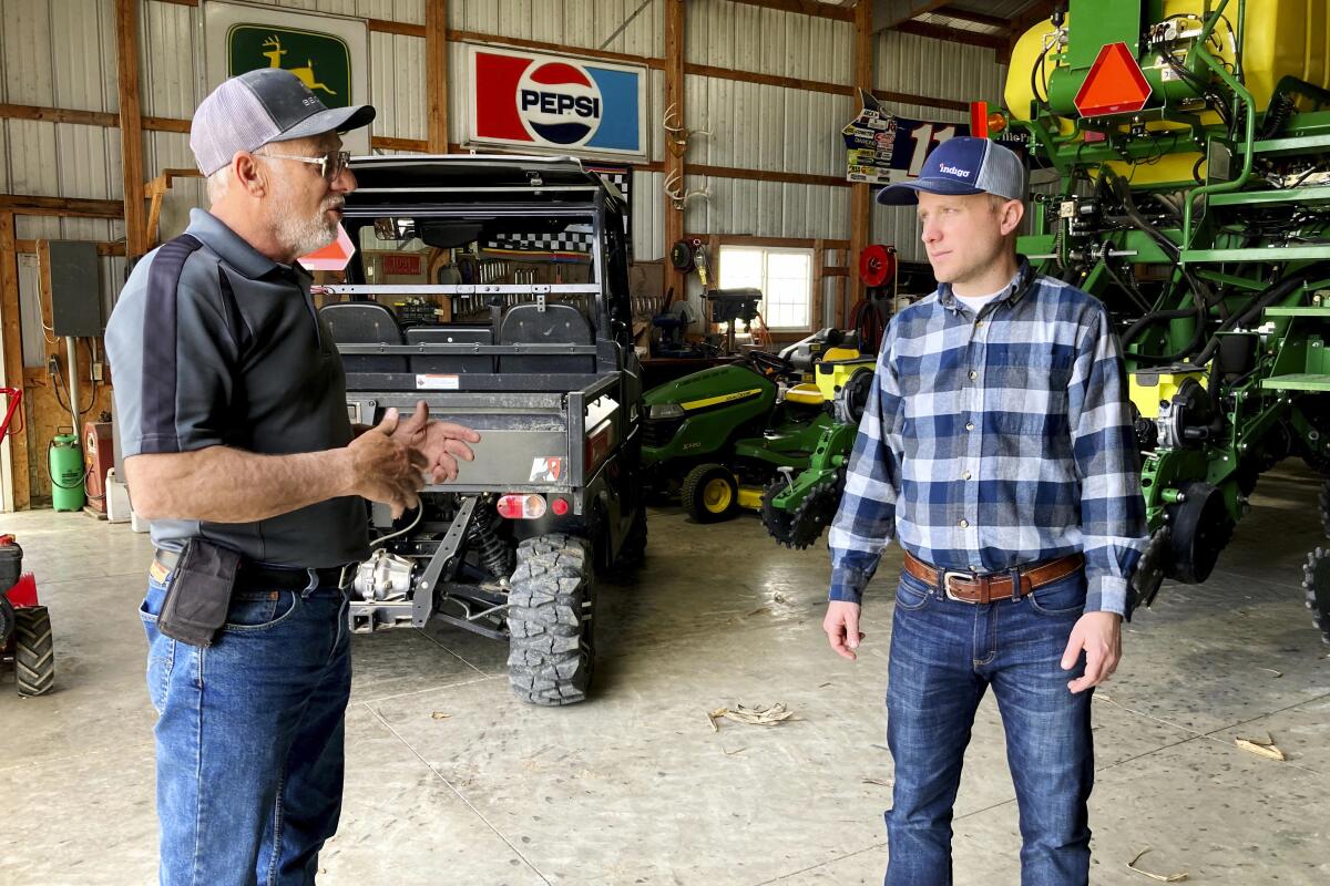 Farmer Rick Clifton, left, talks with Bryan Randall, an agronomist with Indigo Agriculture in Orient, Ohio.