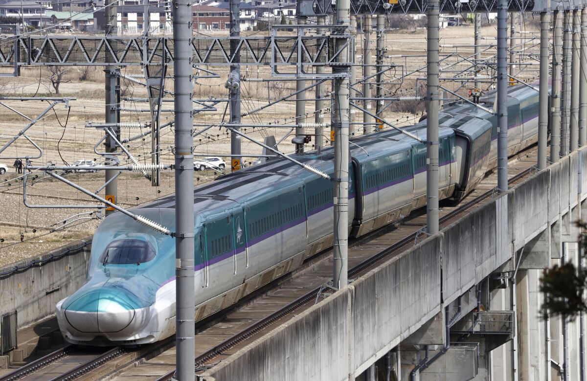 A partially derailed express train sits following an earthquake in Shiroishi, Miyagi prefecture, northern Japan Thursday, March 17, 2022. A powerful earthquake struck off the coast of Fukushima in northern Japan on Wednesday night, smashing furniture, knocking out power and killing some people. A small tsunami reached shore, but the low-risk advisory was lifted by Thursday morning. (Kyodo News via AP)