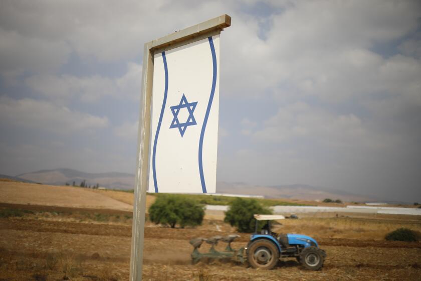 A Palestinian man works on a farm near Bardala, in the Israeli-occupied West Bank, Wednesday, Sept. 11, 2019. Israeli Prime Minister Benjamin Netanyahu’s election eve vow to annex the Jordan Valley if he is re-elected has sparked an angry Arab rebuke and injected the Palestinians into a campaign that had almost entirely ignored them. (AP Photo/Ariel Schalit)