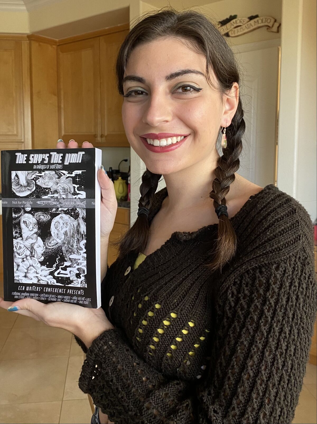 Sophie Camilleri with the 10th anniversary anthology, The Sky’s the Limit.