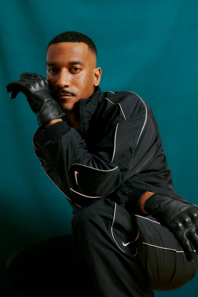 Sean Bankhead in a black tracksuit and black gloves.