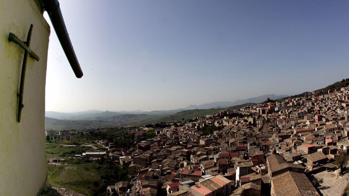 A crucifix looms over the Sicilian town of Corleone, the ancestral home of the late Mafia boss Salvatore "Toto" Riina.